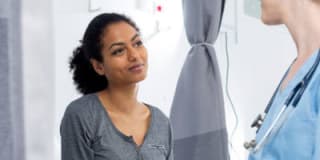 Young woman speaking with doctor in office