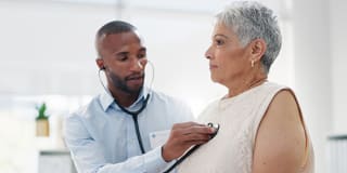 a doctor listening to a patient's heart
