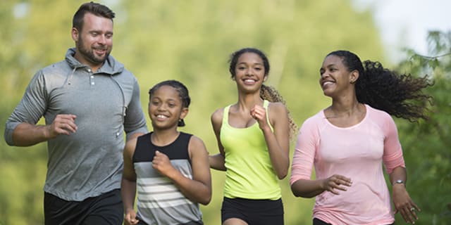 diverse family jogging together