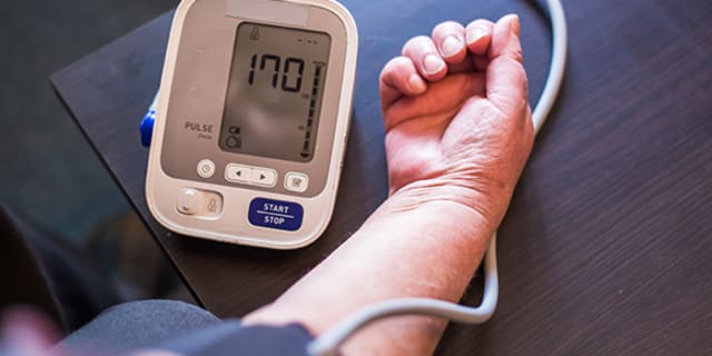 A person using a blood pressure monitor