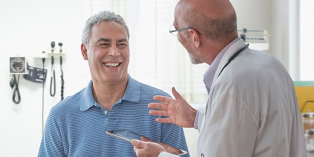 Man with doctor discussing lung cancer screening
