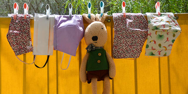 clothes line of cloth masks and stuffed animal bunny