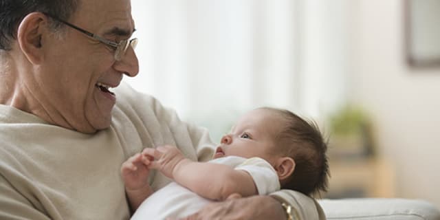 grandfather holding baby