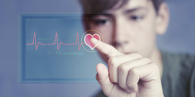 A teen looking at a heart rhythm report