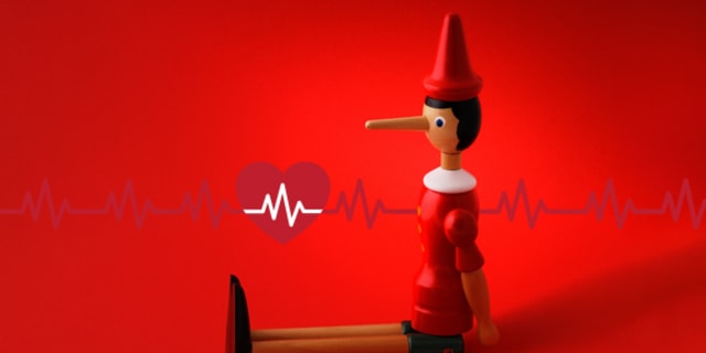 pinocchio doll sitting in front of a heart and heart rhythm, illustrating fibs about afib
