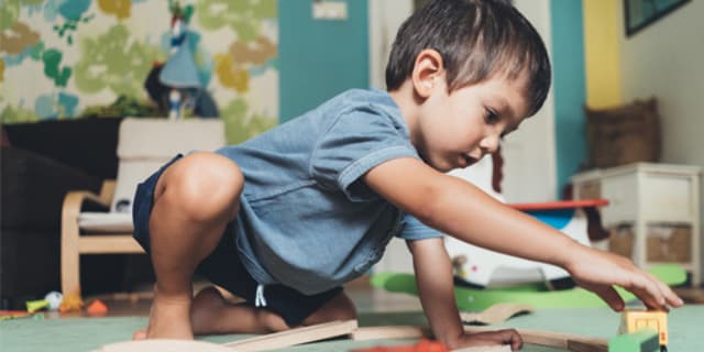 a child playing with trains