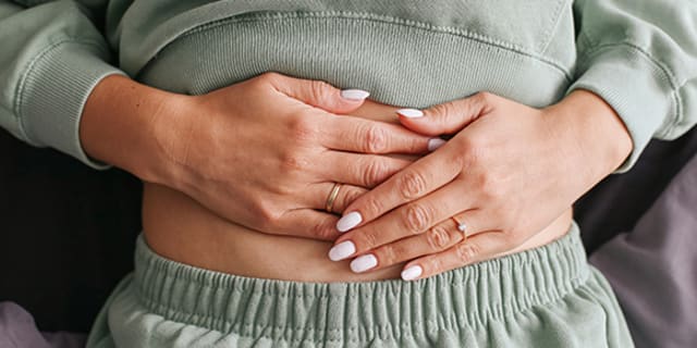 woman with hands on stomach