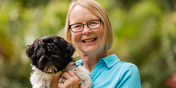 Patient Debbie poses with her dog