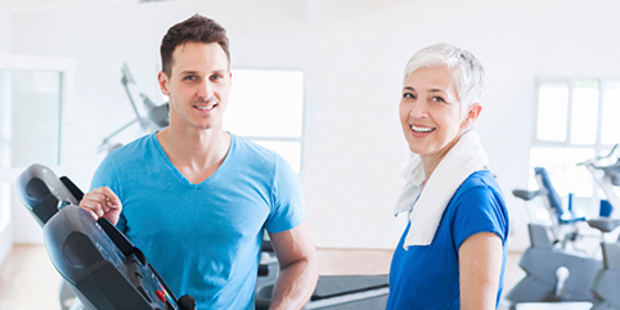 medical professional working with patient on treadmill