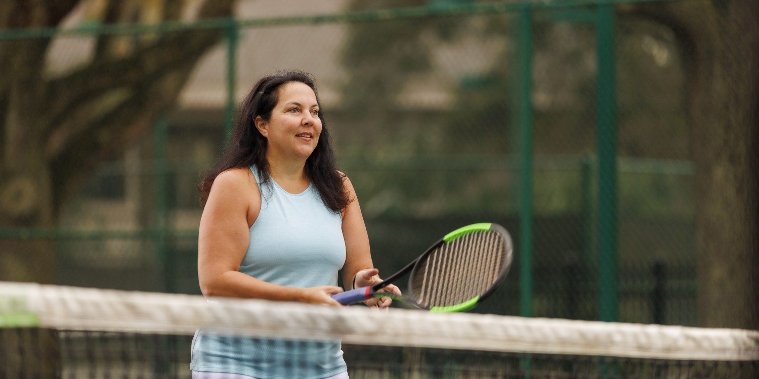 a healthy woman plays tennis after finding a long-term weight loss solution -- bariatric surgery