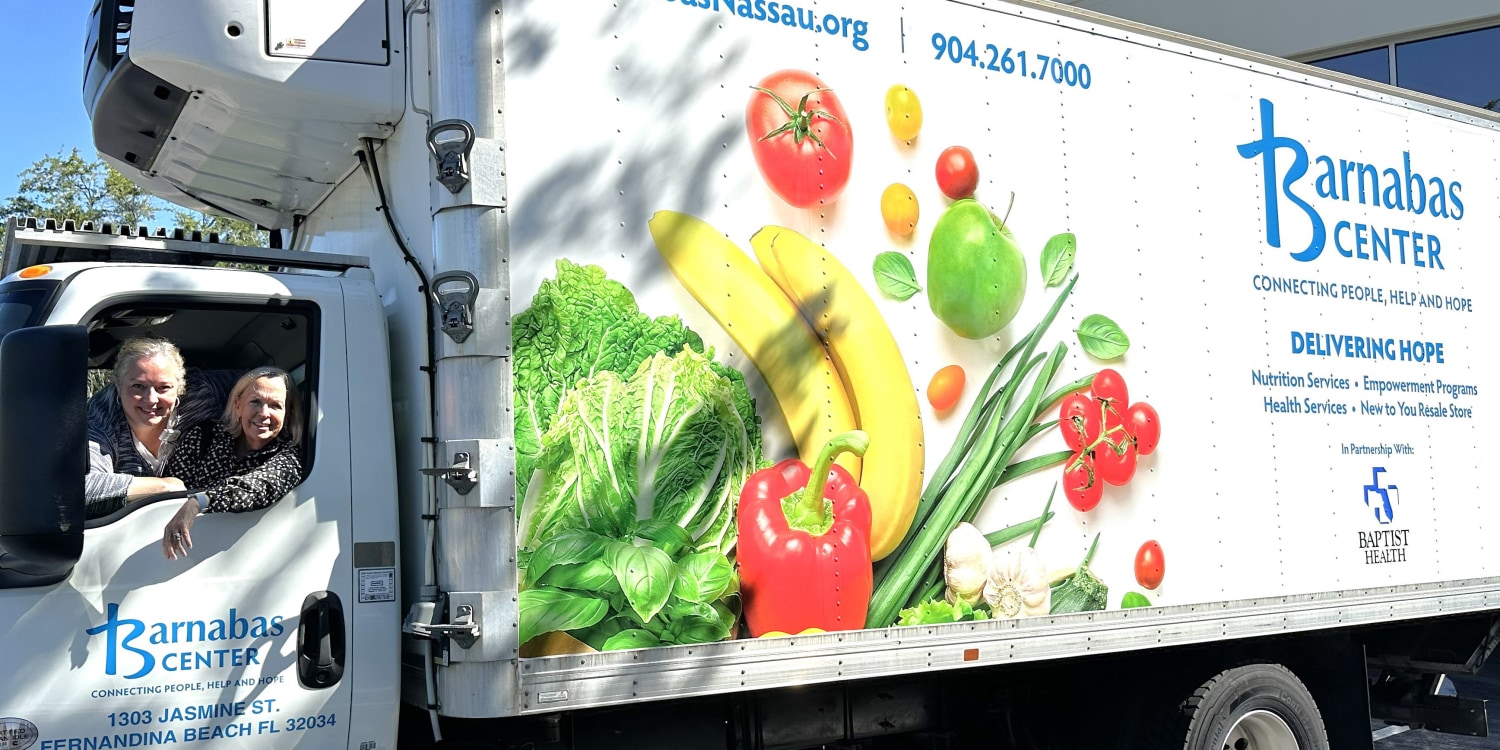 2 smiling woman in a Barnabas Center delivery truck