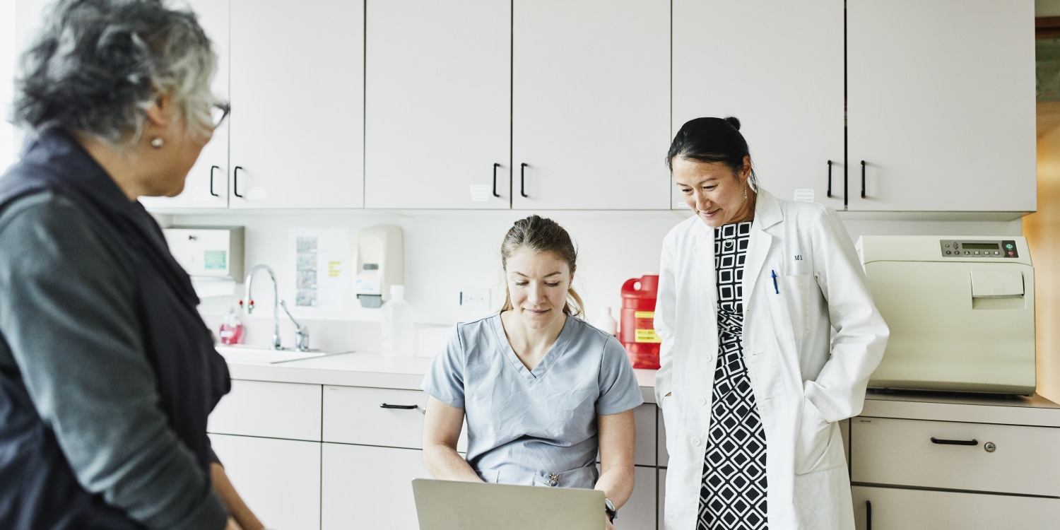 physicians talk with patient in a doctor's office