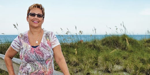 woman standing by the dunes of a beach