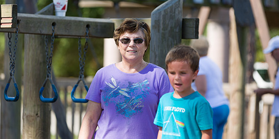 grandmother on playground with grandson
