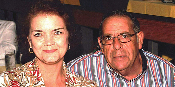 photo of wife and husband, Susan and Jim Taylor, sitting together in a restaurant, smiling