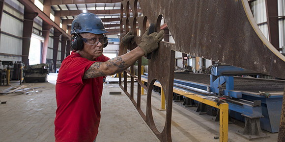man working with metal in a factory
