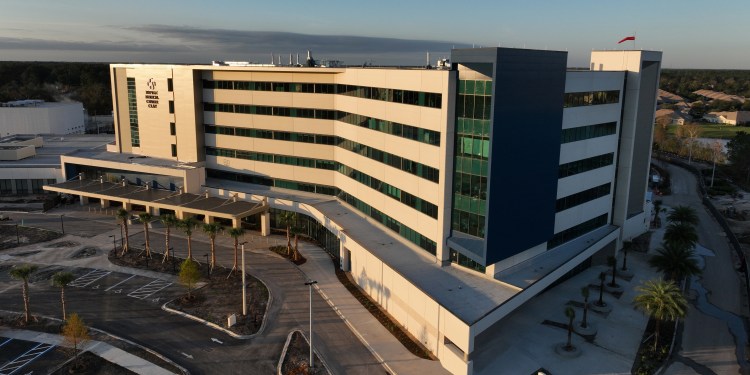 aerial photograph of the Baptist Medical Center Clay building with morning light shining on the front of building and blue skies behind.