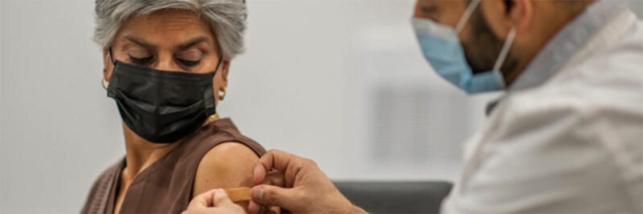 middle-aged woman getting her covid-19 vaccine