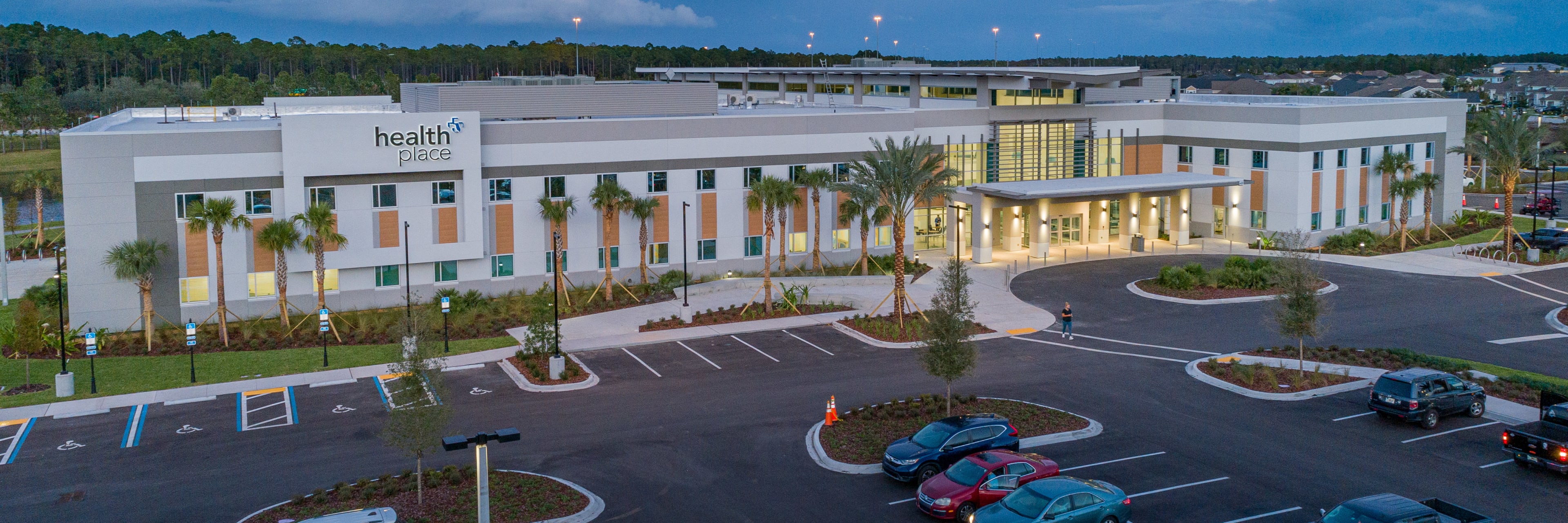 an exterior view of the HealthPlace at Nocatee building in the evening