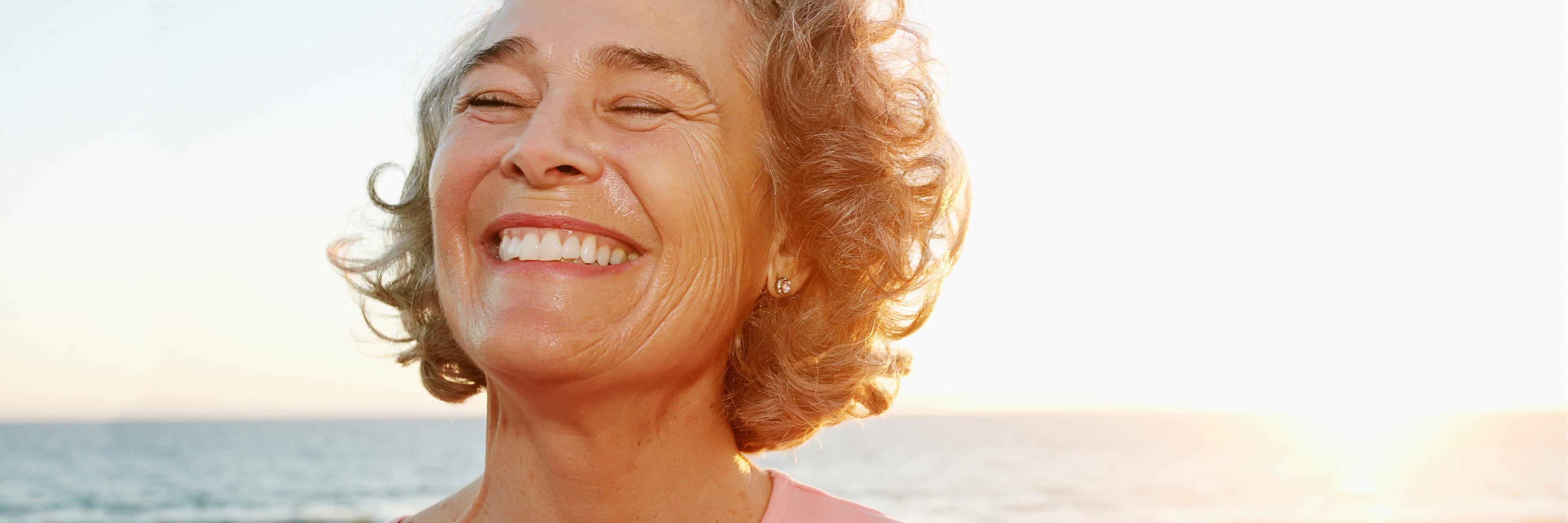 close up of woman smiling at beach