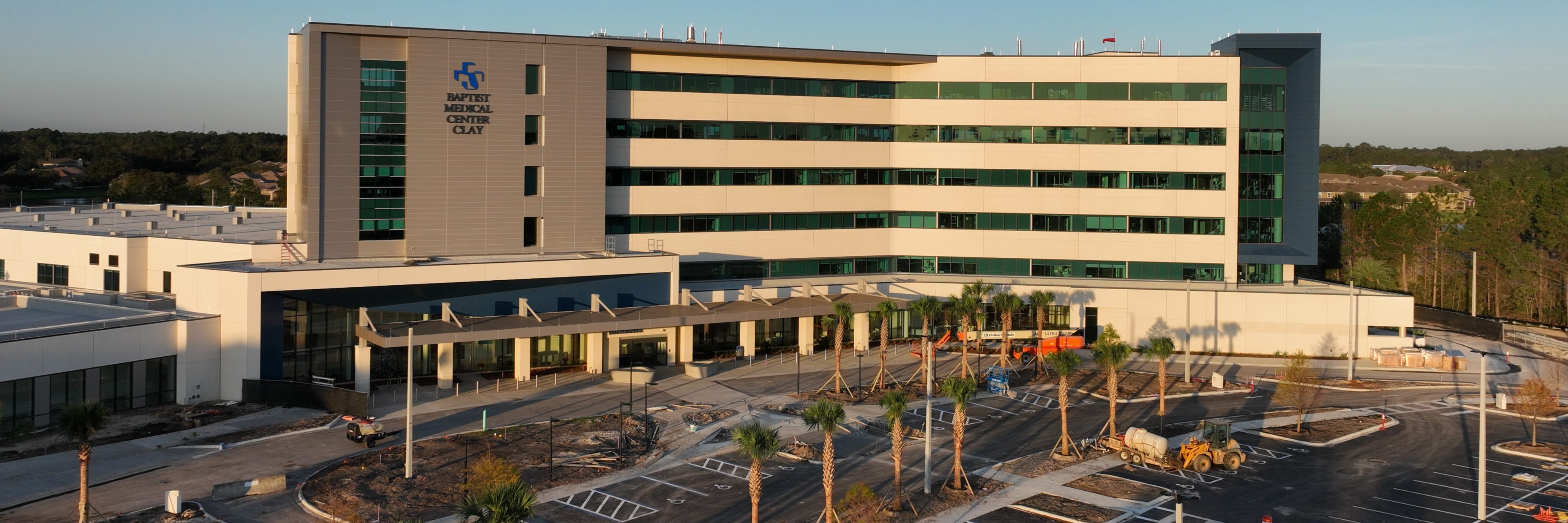 aerial photograph of the Baptist Medical Center Clay building with morning light shining on the front of building and blue skies behind.