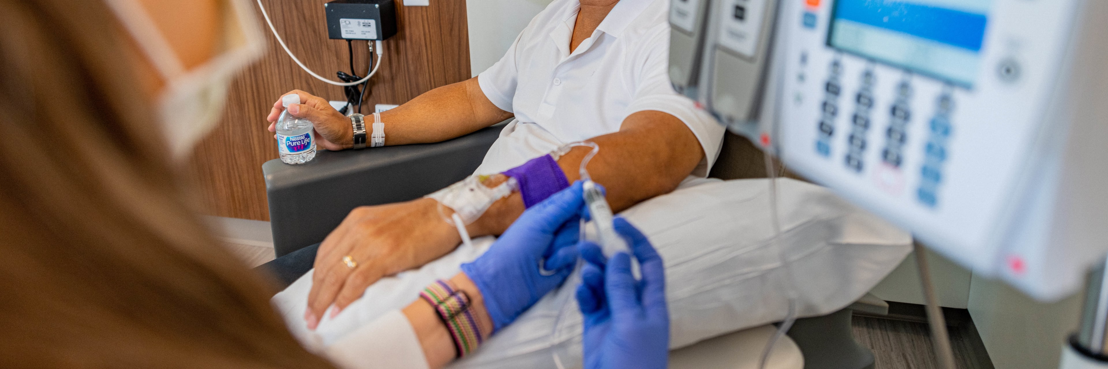 patient receiving intravenous (IV) therapy in infusion center