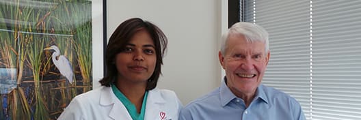 Doctor standing with patient for photo