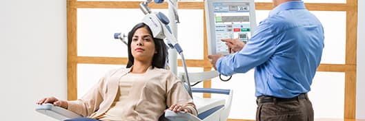 woman receiving Transcranial Magnetic Stimulation treatment