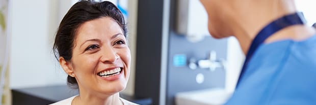 close up of woman smiling up at a healthcare professional
