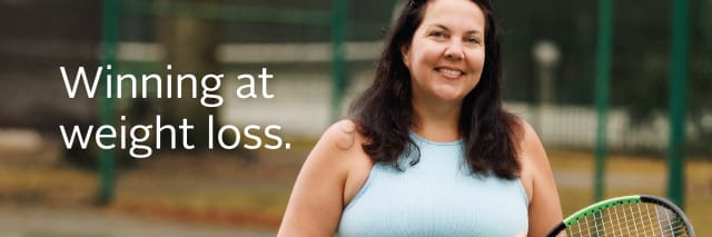 A woman who had weight loss surgery stands on a tennis court holding a ball and racquet while smiling. Text reads "Winning at weight loss"