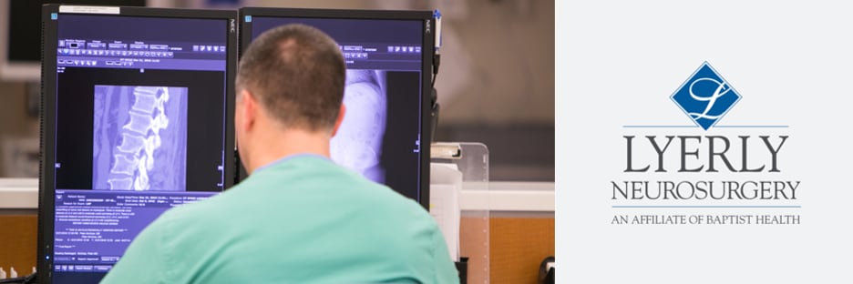 male medical tech looking at an image of a spine on a computer beside the logo of Lyerly Neurosurgery