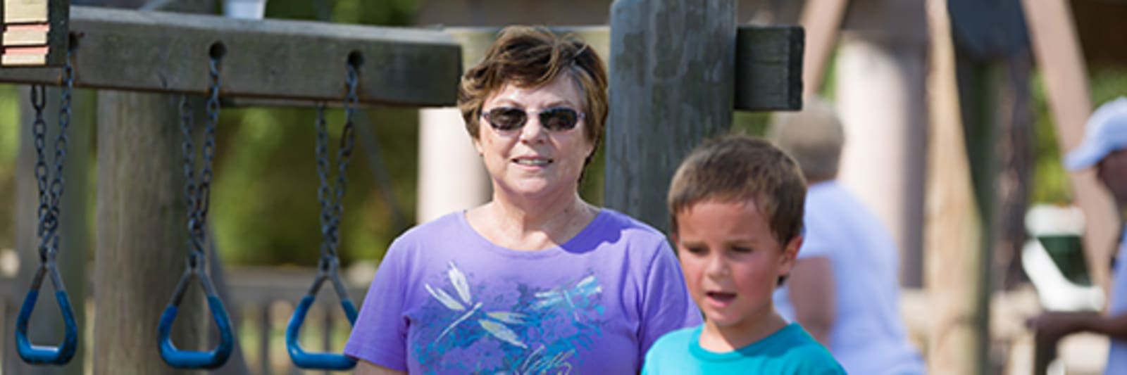 grandmother on playground with grandson