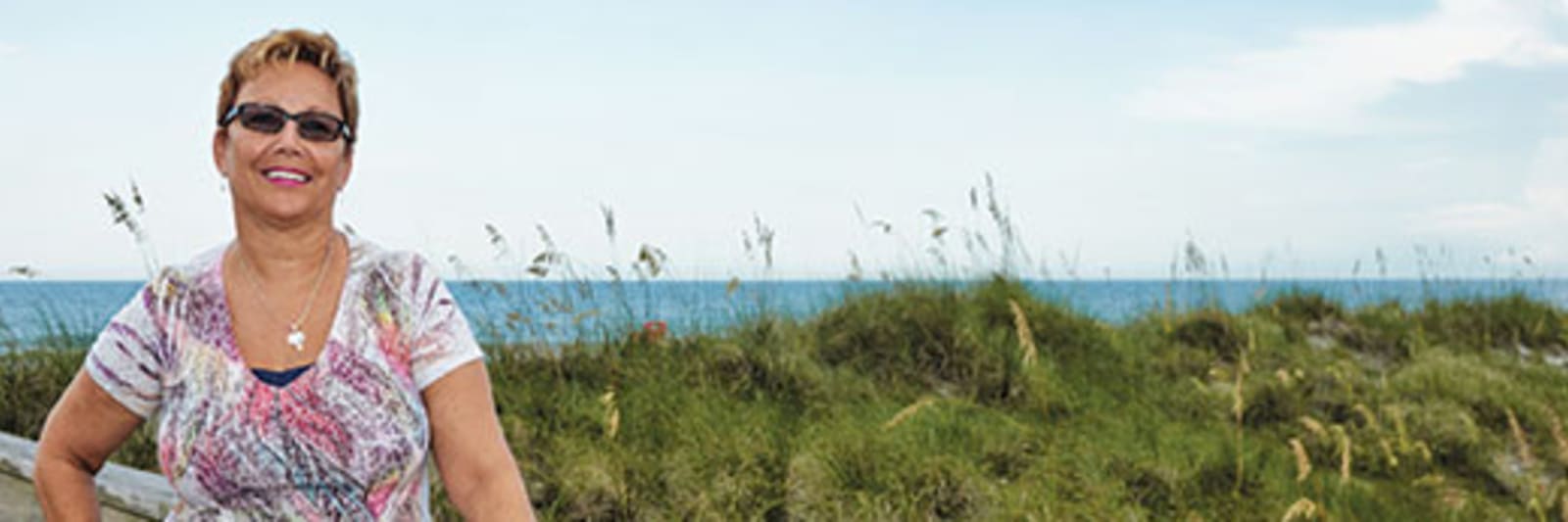 woman standing by the dunes of a beach