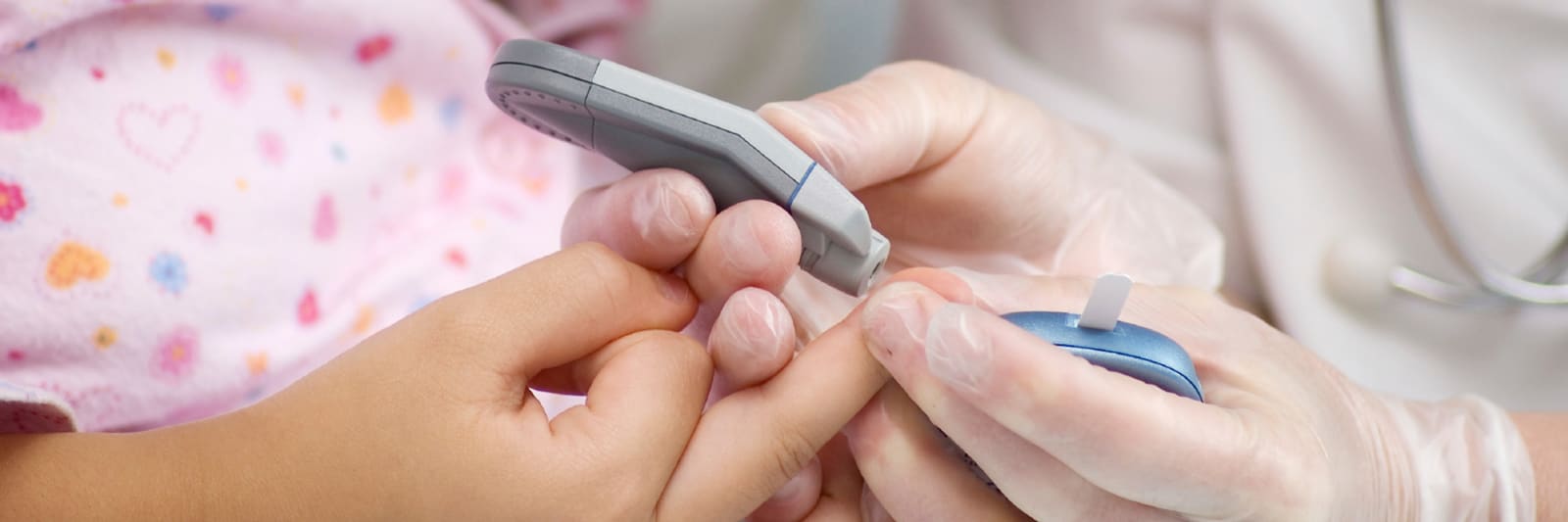 close up of child getting a finger prick blood test