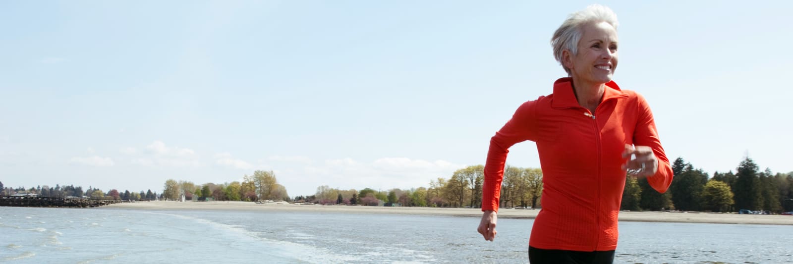 woman running along the water