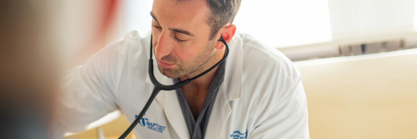 close up of baptist doctor sitting with a patient
