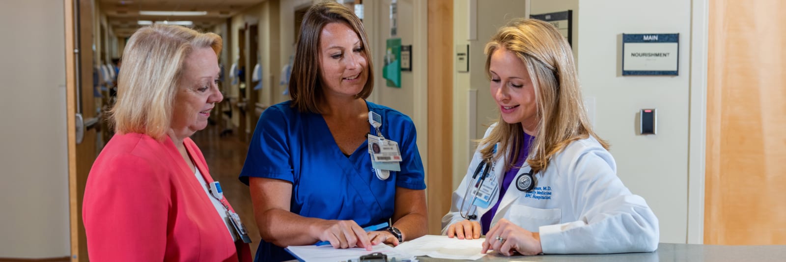 baptist doctor talking with a few other hospital personnel 