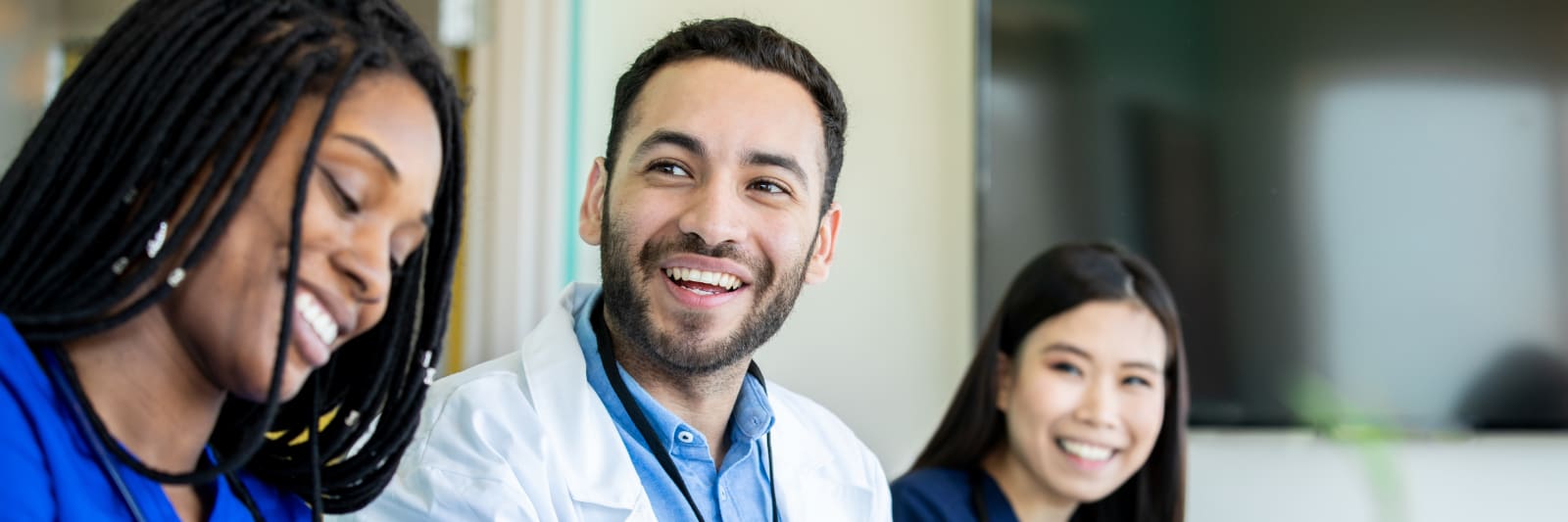 Medical students smile during meeting in conference room