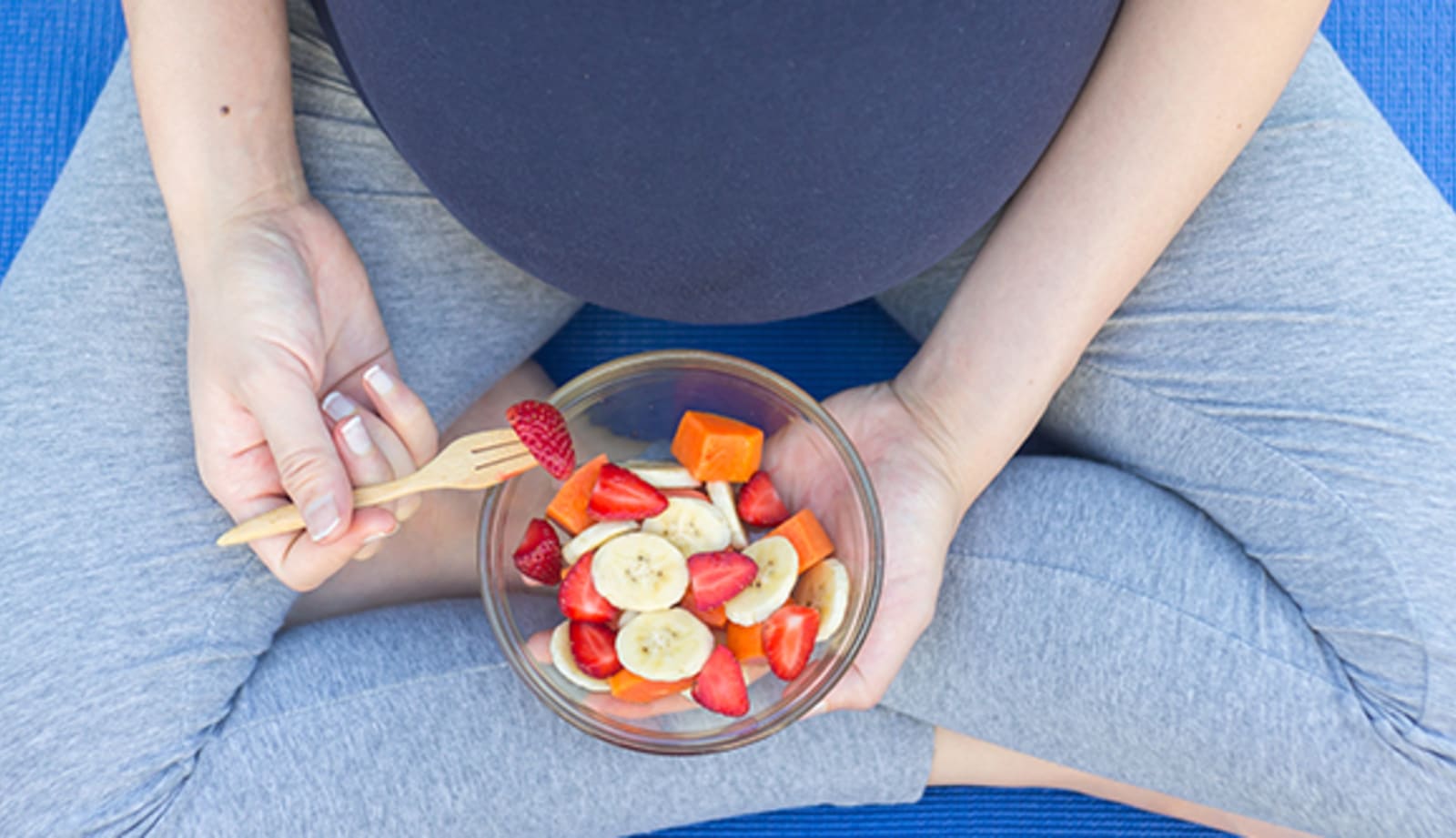 Pregnant mother eating fruit