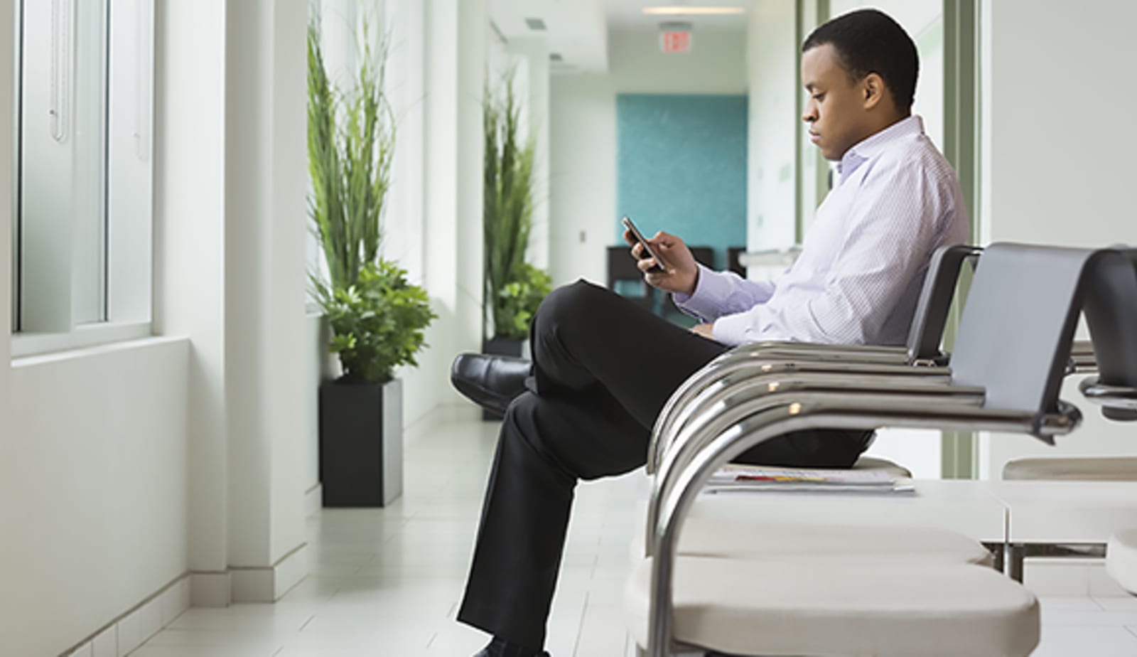 Man sitting in waiting room after receiving a health diagnosis