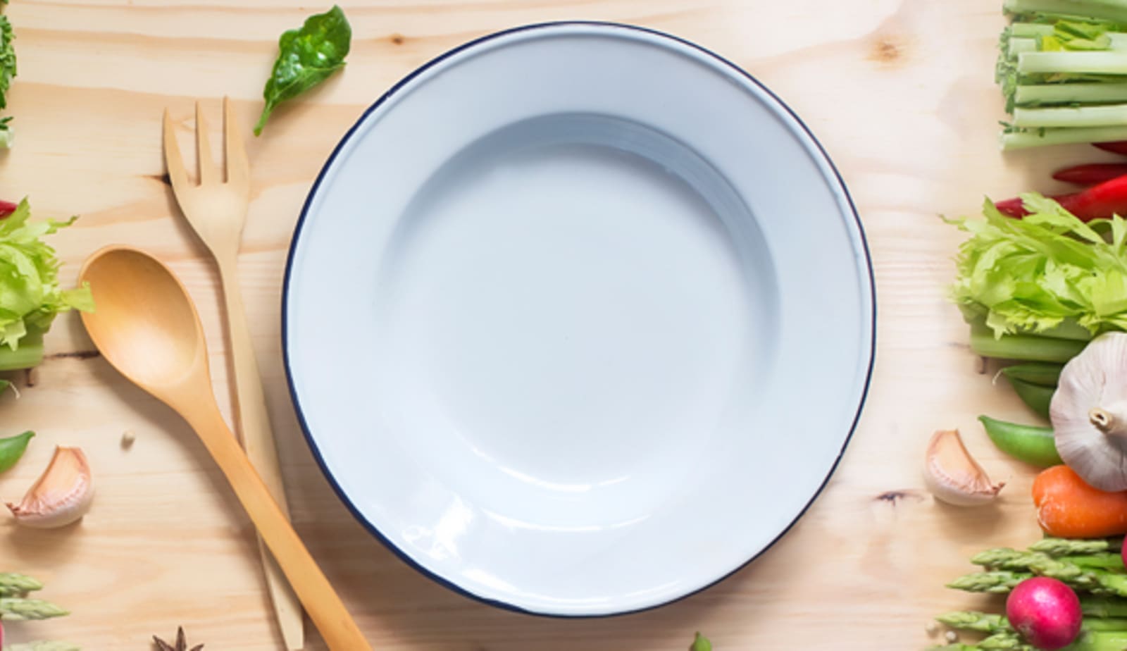 plate, spoon, fork and fresh vegetables