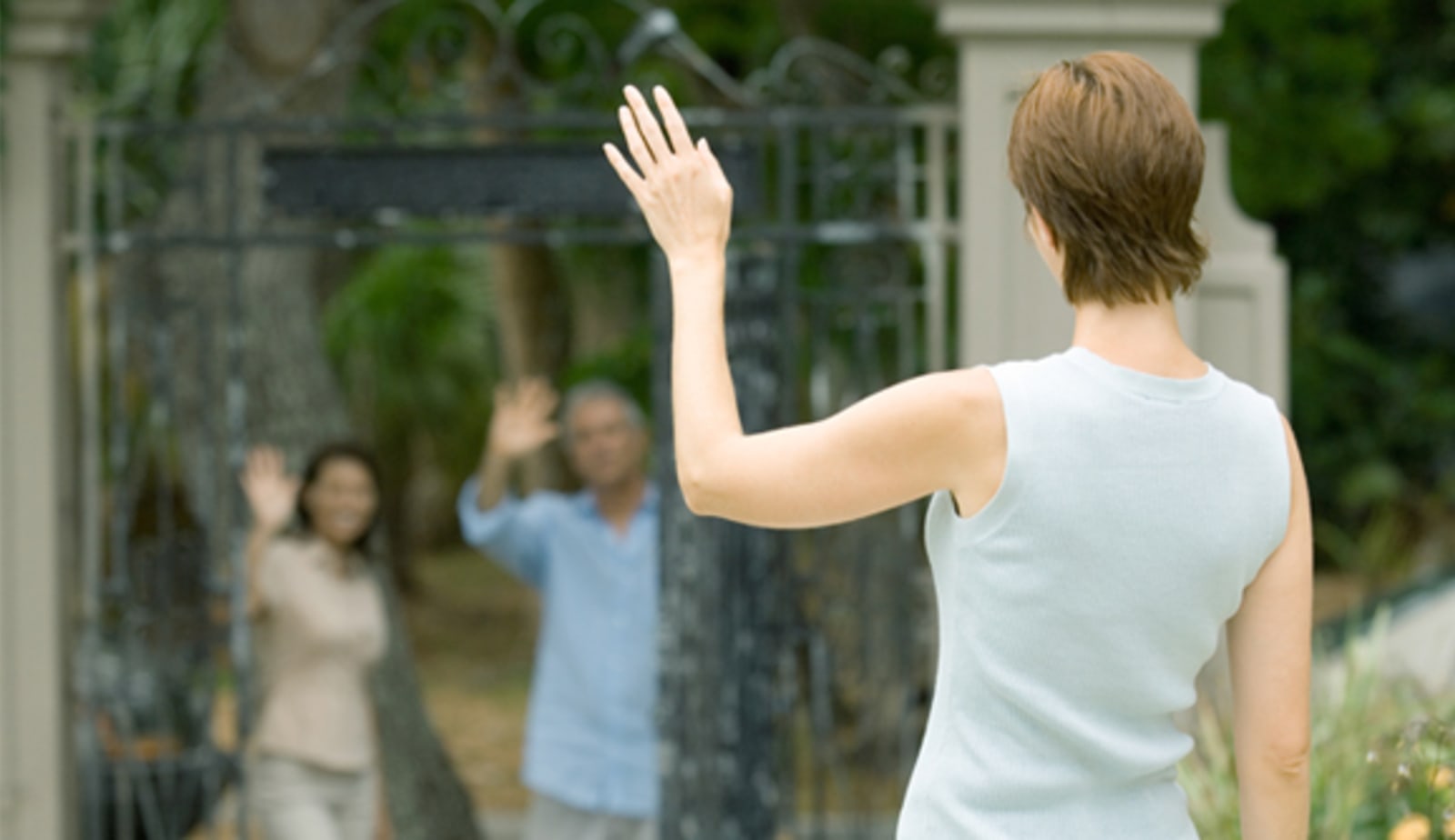 Woman waving at friends from a distance