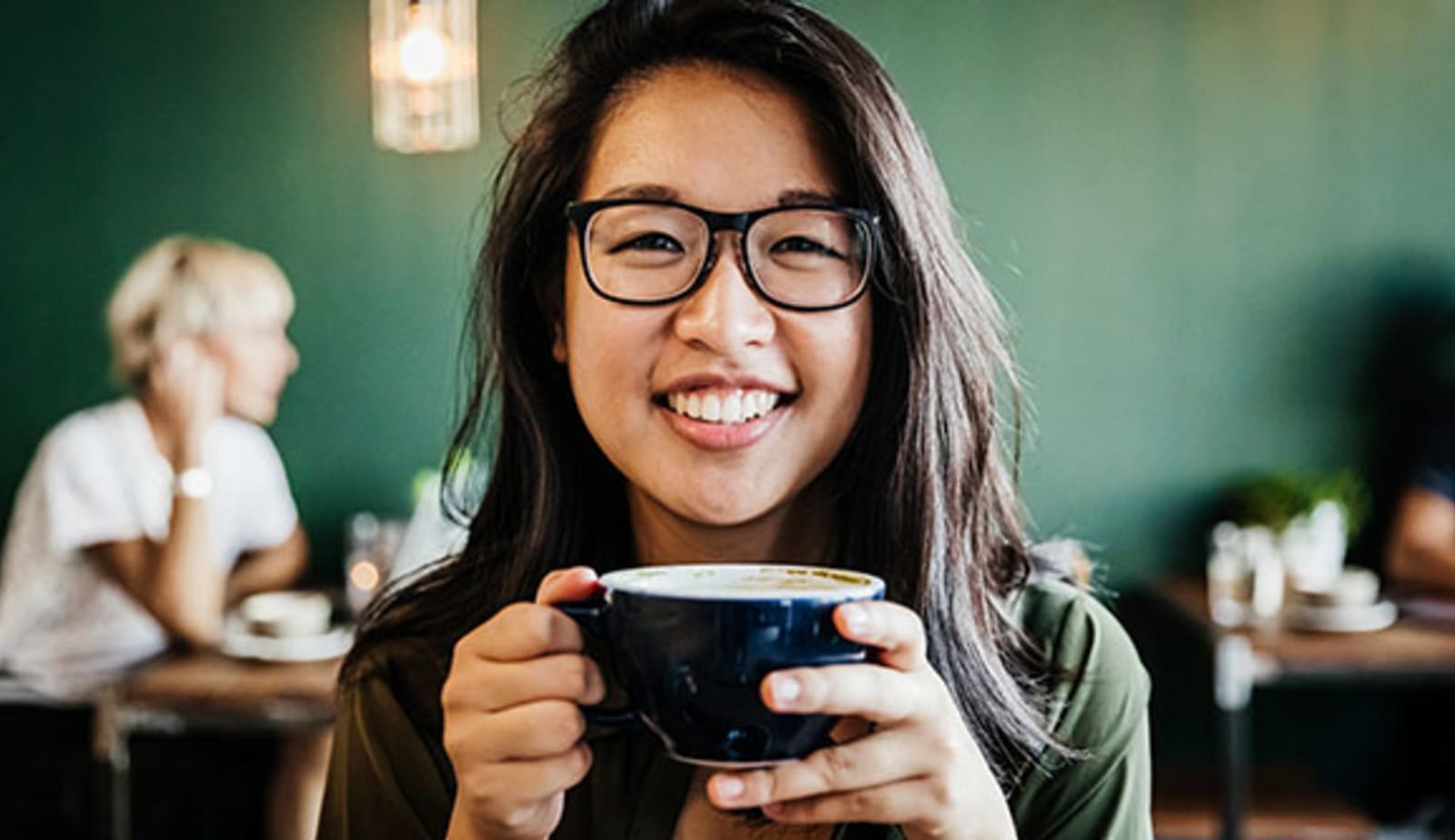 A woman drinking a cup of coffee