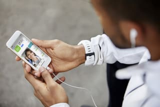 Afro american man looking at his phone. Close-up of hands and smart phone.