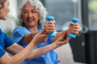 senior with physical therapist