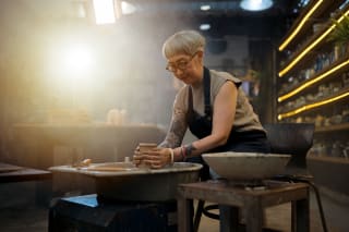 woman sitting at a pottery wheel
