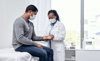 A doctor checks a patient's pulse