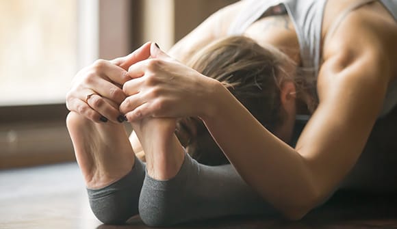 woman gently stretching to help keep her joints healthy and  keep joints lubricated