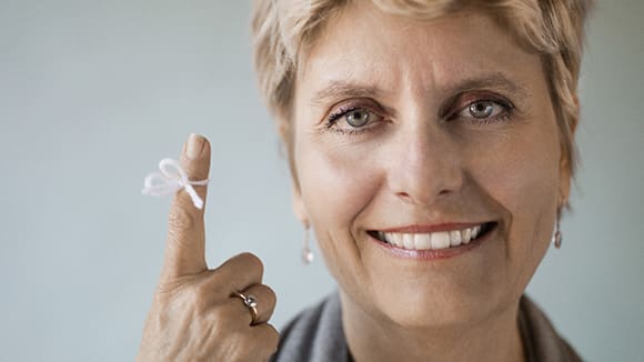 close up of woman with a white string tied around her finger