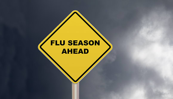 yellow diamond sign that says "flu season ahead"